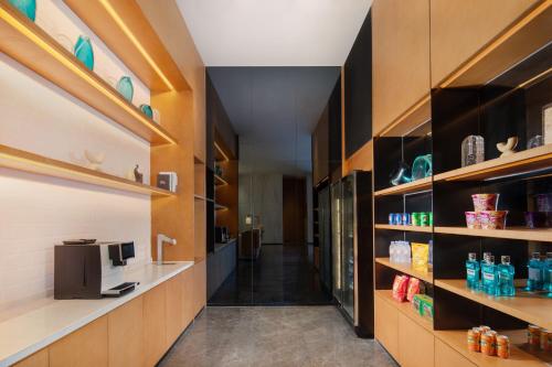 a hallway of a kitchen with wooden shelves at Fairfield by Marriott Zhoushan Putuo in Zhoushan