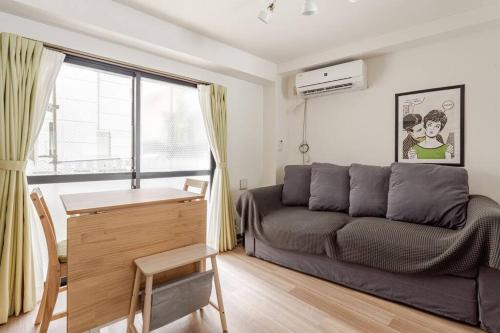 a living room with a couch and a desk at Papa101 in Tokyo