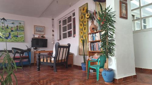 a living room with two chairs and a book shelf at Joli appartement au terrasse pour 3 personnes in Essaouira