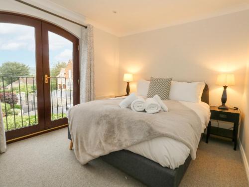 Un dormitorio con una cama grande con toallas. en Sunningdale Rise, en Weymouth