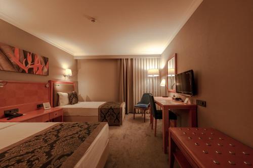 a hotel room with two beds and a desk at La Quinta by Wyndham Giresun in Giresun