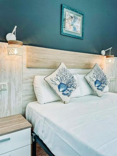 a bedroom with a bed with two pillows on it at Hotel San Martin in Altafulla