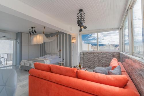 a living room with a couch and a bedroom at AcroLofts M62 in Athens