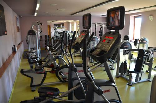 a gym with a bunch of tread machines at Hotel Rajská zahrada in Nové Město nad Metují