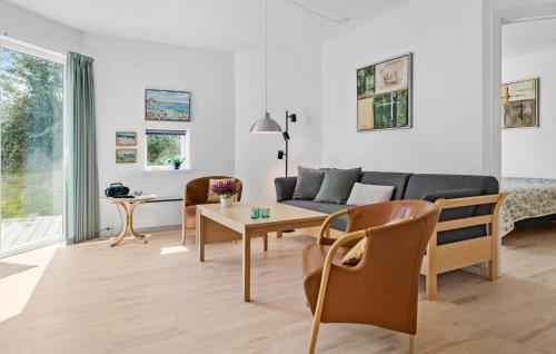 a living room with a couch and a table at Gudhjem Søpark Lejl 51 in Gudhjem