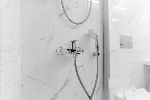 a shower with a shower head in a bathroom at AcroLofts M62 in Athens