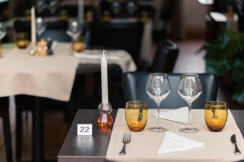 a table with four wine glasses on a table at Hôtel Restaurant La Croix Verte Vich in Vich