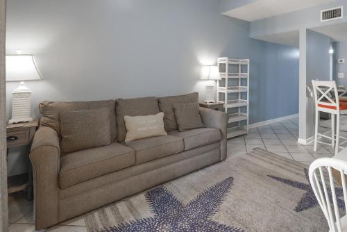 a living room with a couch and a table at Sugar Beach 353 in Gulf Shores