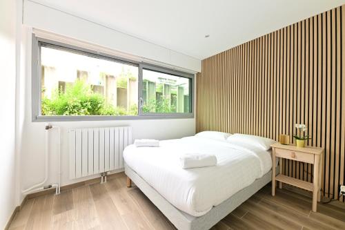 une chambre avec un grand lit et une fenêtre dans l'établissement Appartement Climatisé Porte Versailles, à Paris