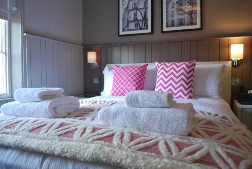 a bedroom with a bed with towels on it at The Lawrance Luxury Aparthotel - York in York