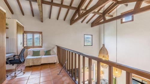 a living room with a staircase and a chair at La Casa 1950 Montefrío by Ruralidays in Montefrío