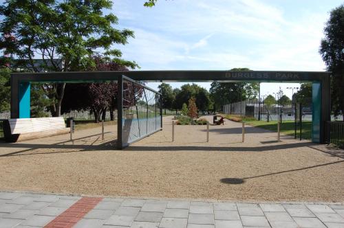 a bus stop in a park with a sign at Pasha Hotel - 3* Boutique Hotel in London