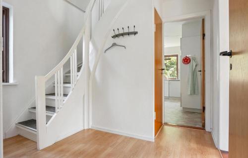 a hallway with white walls and a white stair case at Lovely Home In Dronninglund With Wifi in Dronninglund