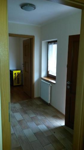 an empty room with a door and a window at Guest House Meat Heads Pub in Komárno