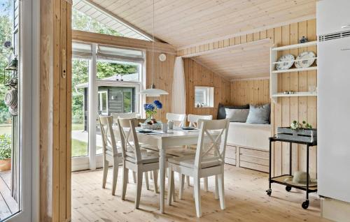 a kitchen and dining room with a table and chairs at 2 Bedroom Cozy Home In Højslev in Højslev