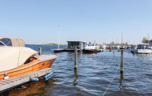 a group of boats docked at a dock in the water at Kraaijennest in Uitgeest