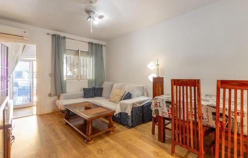a living room with a couch and a table at Stunning Home In San Fulgencio in San Fulgencio