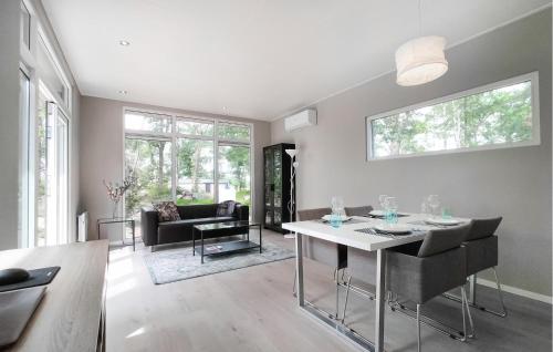 a living room with a table and a couch at 2 Bedroom Amazing Home In Hellendoorn in Hellendoorn