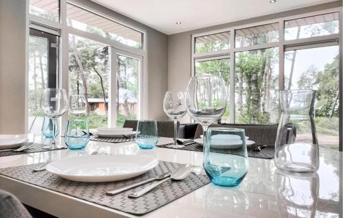 a dining table with wine glasses on it at 2 Bedroom Amazing Home In Hellendoorn in Hellendoorn