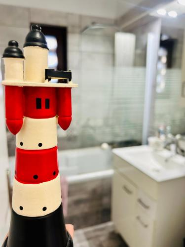 a person holding a snowman bottle in a bathroom at Snug apartament in Iaşi