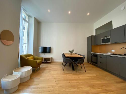 une cuisine et une salle à manger avec une table et des chaises dans l'établissement Appartement Aboukir, à Paris