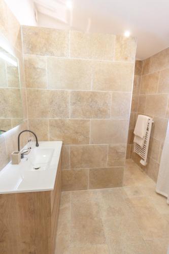 a bathroom with a sink and a shower at Le Baguier in La Roquebrussanne