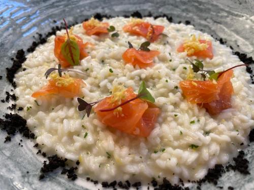 a plate of risotto with carrots on top of it at Hotel Franca in Milano Marittima