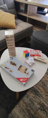 a white coffee table with books and other items on it at Студио Нико - Царево in Tsarevo