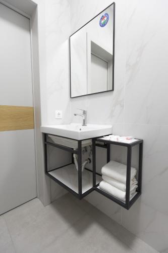 a bathroom with a sink and a mirror at Zhagalau Resort in Aktau