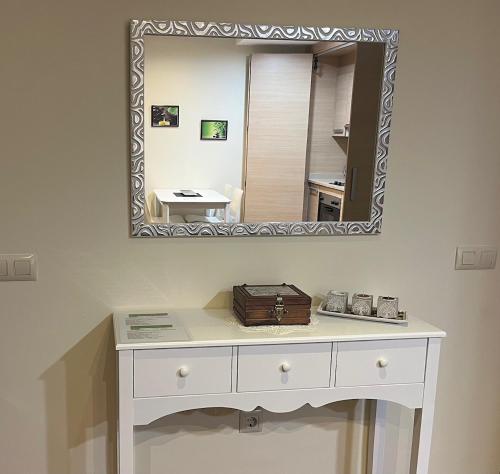 a white dressing table with a mirror on a wall at Apartamento El Mirador de La Farga in Arbúcies