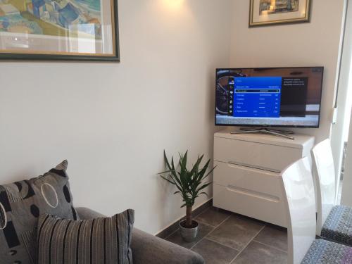 a living room with a tv on a dresser at Harmony Drasnice in Drasnice