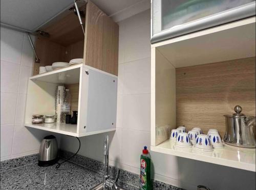 a kitchen with a sink and a cupboard with dishes at Nassma guesthouse in Anfah