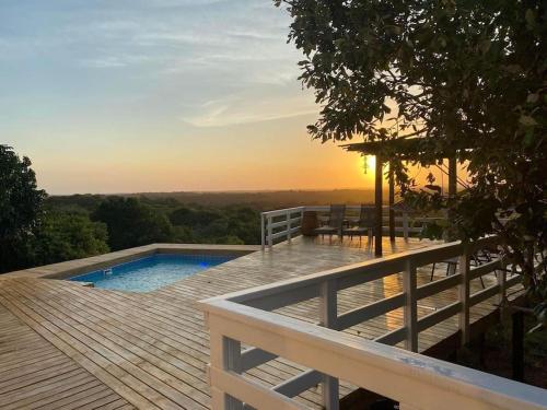 a deck with a swimming pool on top of a house at Sunset Villa 44 in Mateus