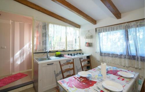 a kitchen with a table and a sink and a table and chairs at Stunning Home In Ne With Kitchen in Ne