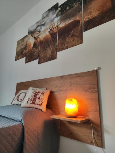 a room with a bed and a candle on a wall at A Casa di Kate in Borno