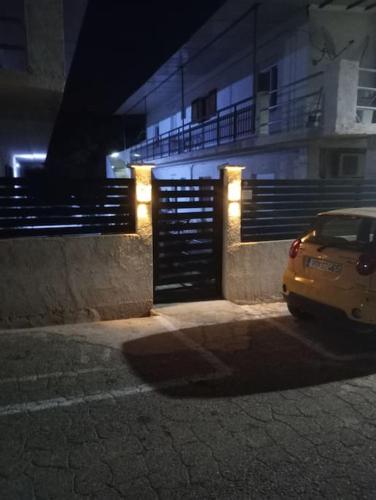 a car parked in front of a building at night at Rallis village apartments in Paralía Akrátas
