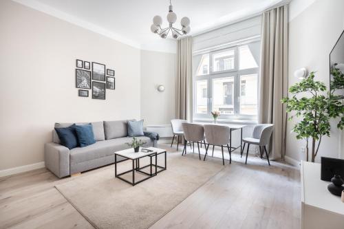 a living room with a couch and a table at A13- Deluxe Apartments, Best Location, by BQA in Budapest