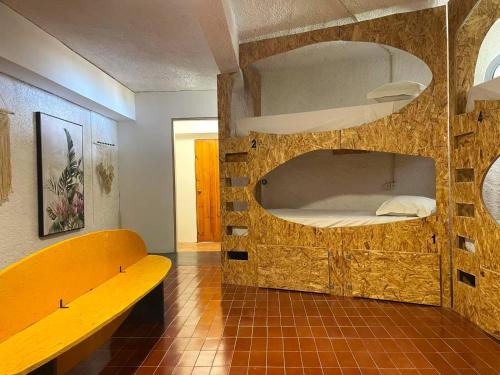 a room with a bench and a bunk bed at Porto Santo Destination in Porto Santo