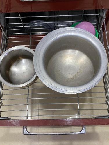 two metal bowls sitting on a rack in an oven at SRT HOMELY STAY WITH All AMENITIES in Hyderabad