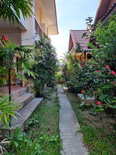 a garden with stairs and plants next to a house at Apache Bar Haad yao in Haad Yao