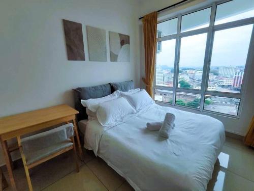 a bedroom with a bed and a desk and a window at G Home 1 - Ipoh City Center Majestic 2R2B in Ipoh