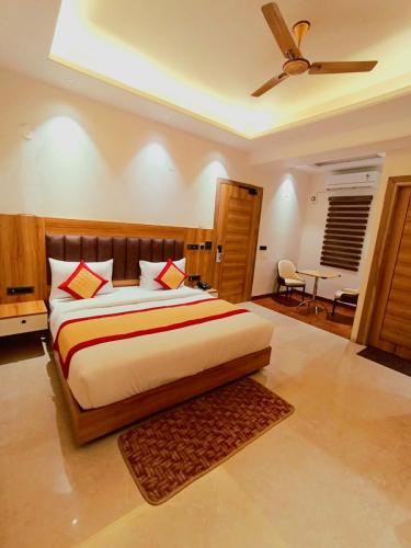 a bedroom with a bed and a ceiling fan at Masaga by Qcent, Gurugram in Gurgaon