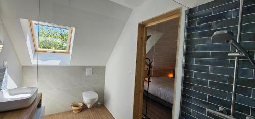 a bathroom with a sink and a toilet and a shower at Gîte L'Ostau 4 étoiles Les Échappées Belles in Antignac