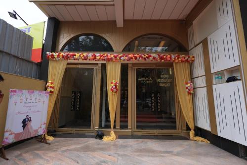 a entrance to a building with a curtain and a sign at Masaga by Qcent, Gurugram in Gurgaon