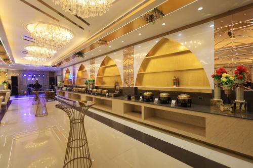 a lobby of a hotel with a buffet line at Masaga by Qcent, Gurugram in Gurgaon