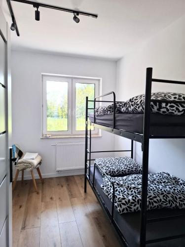 a room with two bunk beds and a window at Apartament z dużym ogródkiem in Rzeszów