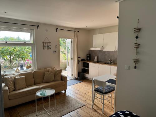 a living room with a couch and a table at Studio appartement 1nul9Noord in Renesse