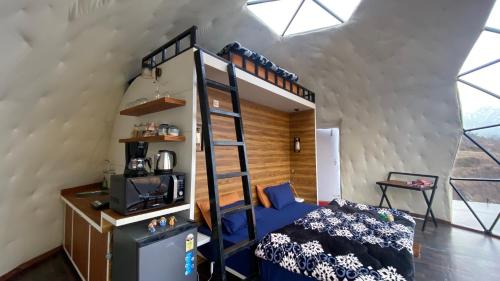 a bedroom with a bunk bed in a room at We Are Made Of Stories in Joshīmath