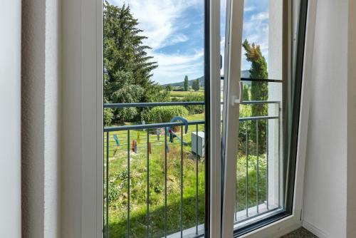 a window with a view of a park at Studio im Grünen und Bodenseenähe in Rielasingen-Worblingen