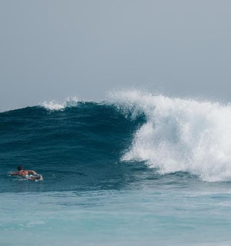 a man riding a wave in the ocean on a surfboard at Fuertevillage in Costa Calma